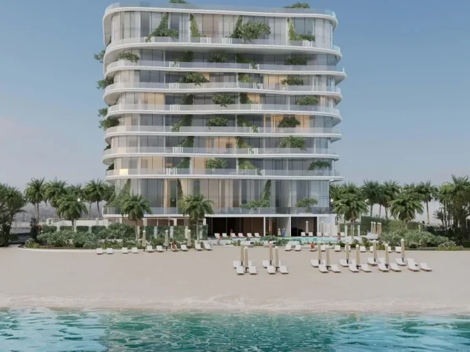 Modern beachfront condo "The Beach House" with lush balconies and poolside loungers by the sea.