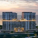 An elevated view of the Costa Mare building at sunset, showcasing its two towers and central amenities.