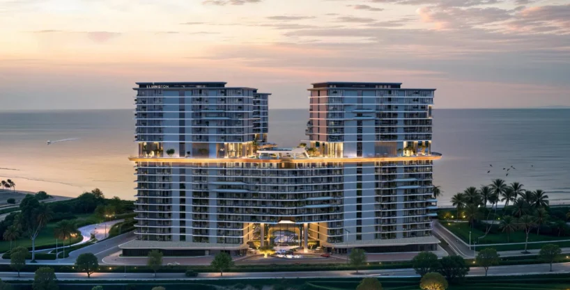 An elevated view of the Costa Mare building at sunset, showcasing its two towers and central amenities.