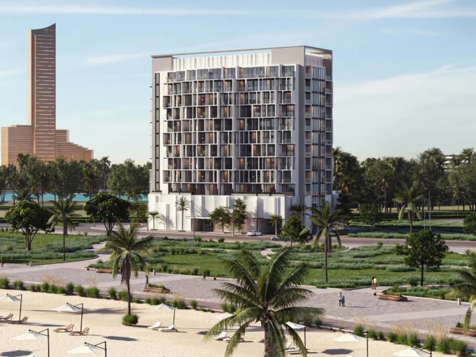 A tall, modern Island Heights building stands near a beach with palm trees and sun umbrellas.