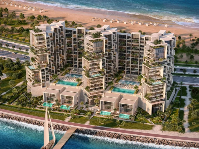 Aerial view of Masa Residences showing beachfront towers, pools, and villas along the coast.