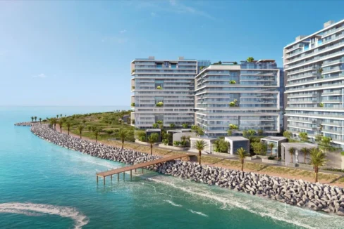 A high-angle shot captures three modern, white Moonstone buildings along a rocky coast.