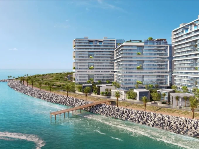 A high-angle shot captures three modern, white Moonstone buildings along a rocky coast.