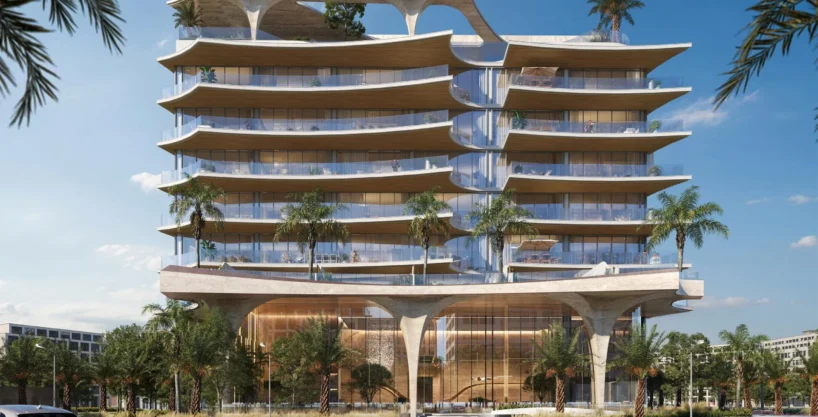 A futuristic Ola Residences building with wavy concrete elements and large balconies is seen from the street.