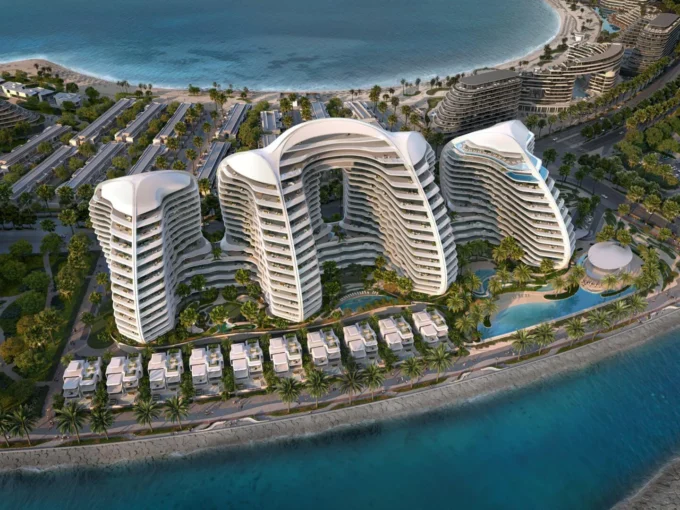 Oystra by Richmind: luxury resort with curved white buildings, villas, and ocean views.