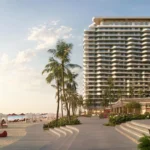 Rosso Bay Residences, a tall building on a sunny beach with palm trees and cabanas.