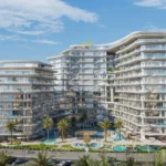 A luxurious, multi-story building, "Taj Wellington Mews", with curved balconies and a central pool area, surrounded by palm trees.