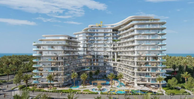 A luxurious, multi-story building, "Taj Wellington Mews", with curved balconies and a central pool area, surrounded by palm trees.