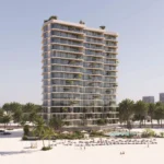 A tall, modern building, "The Beach Vista," with balconies and greenery, overlooks a sandy beach with palm trees and a pool.