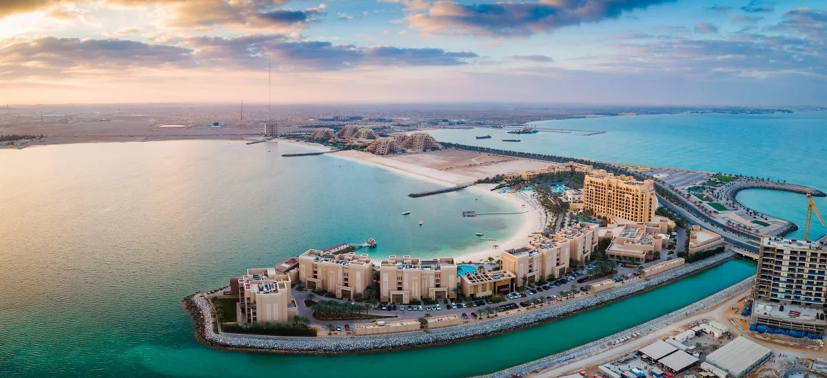 Aerial view of Al Marjan Island, a man-made archipelago, with luxury resorts and beaches.
